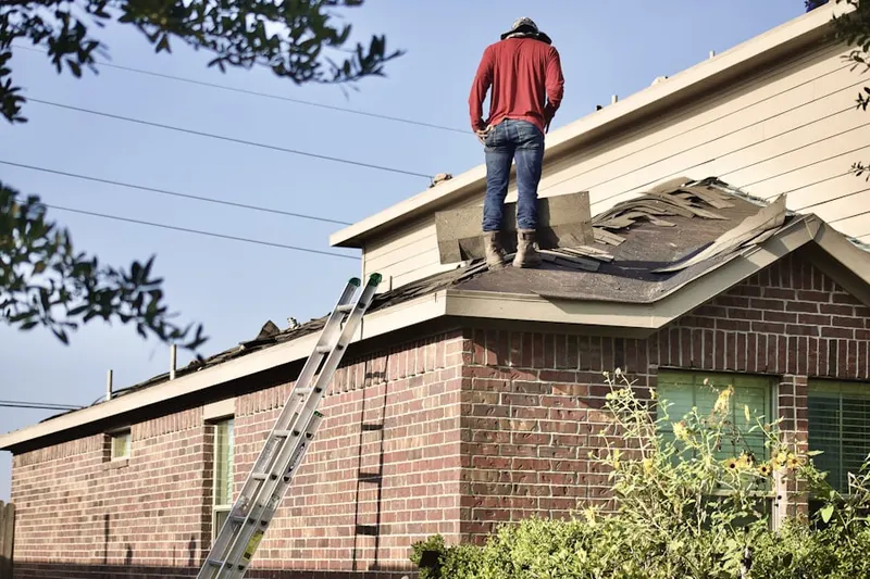 Professional roofer working on a residential roof in Kensington Manor